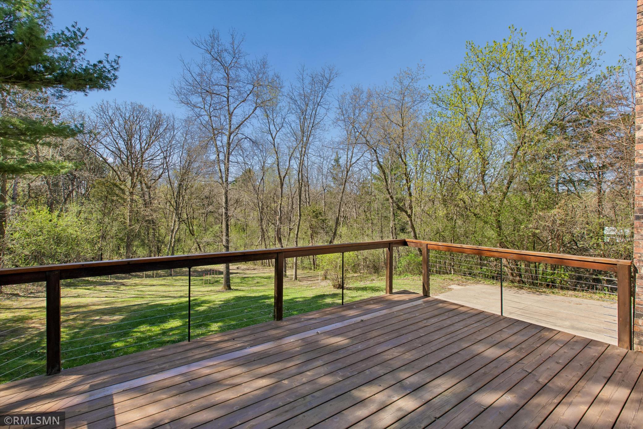 Large deck overlooking the awesome backyard