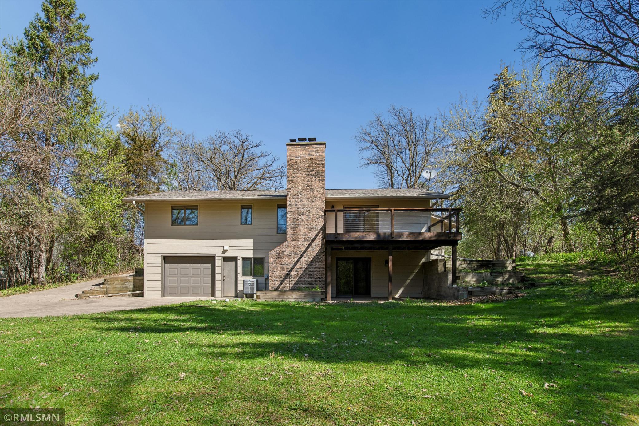 Concrete driveway wraps around the house and down to the workshop down below!
