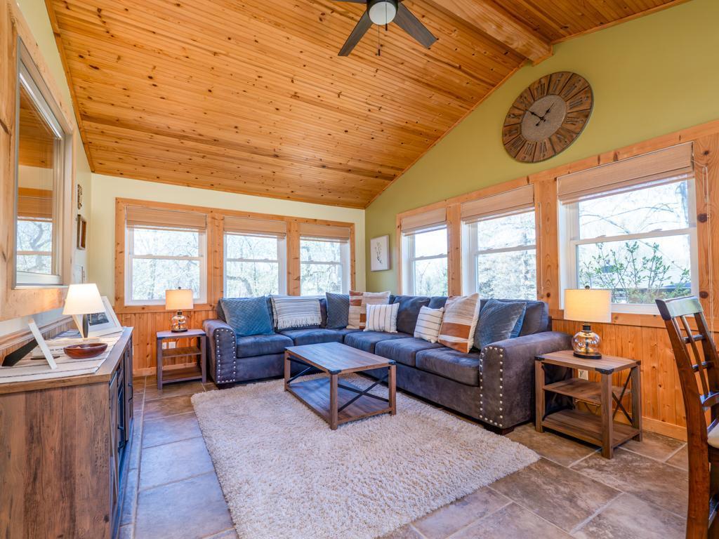 Four-season sun room with vaulted ceiling.