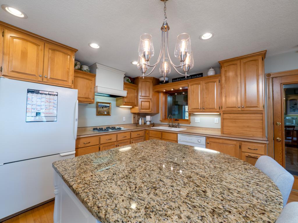 Large center island with granite top.