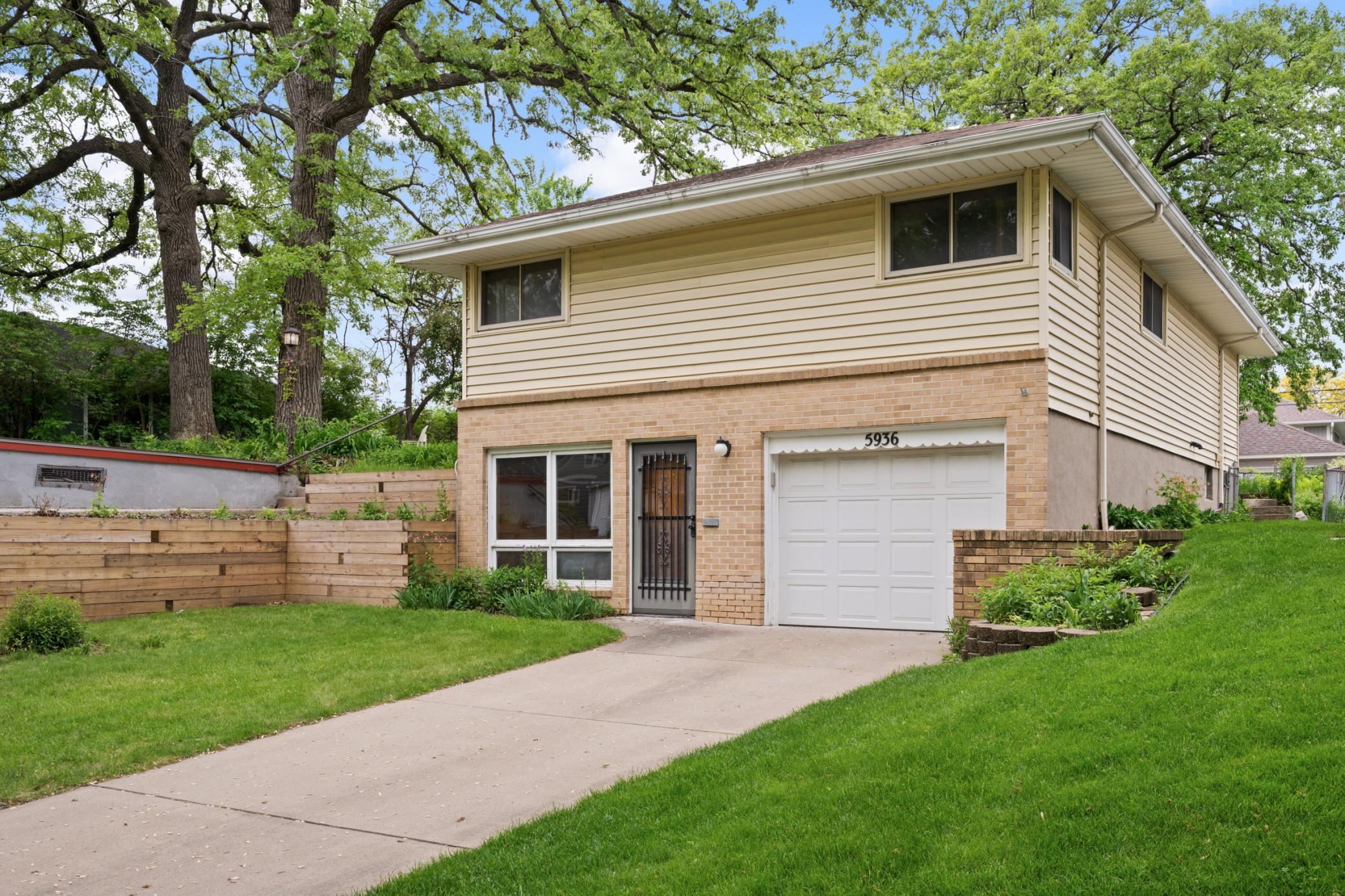 Solid reverse rambler with private driveway and attached garage.