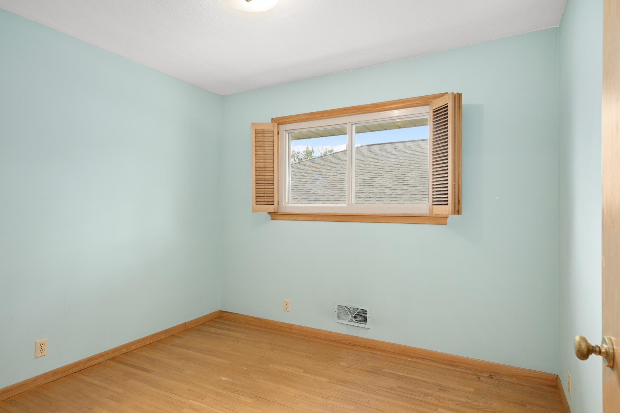 2nd bedroom (11' x 10') with original hardwood floor.