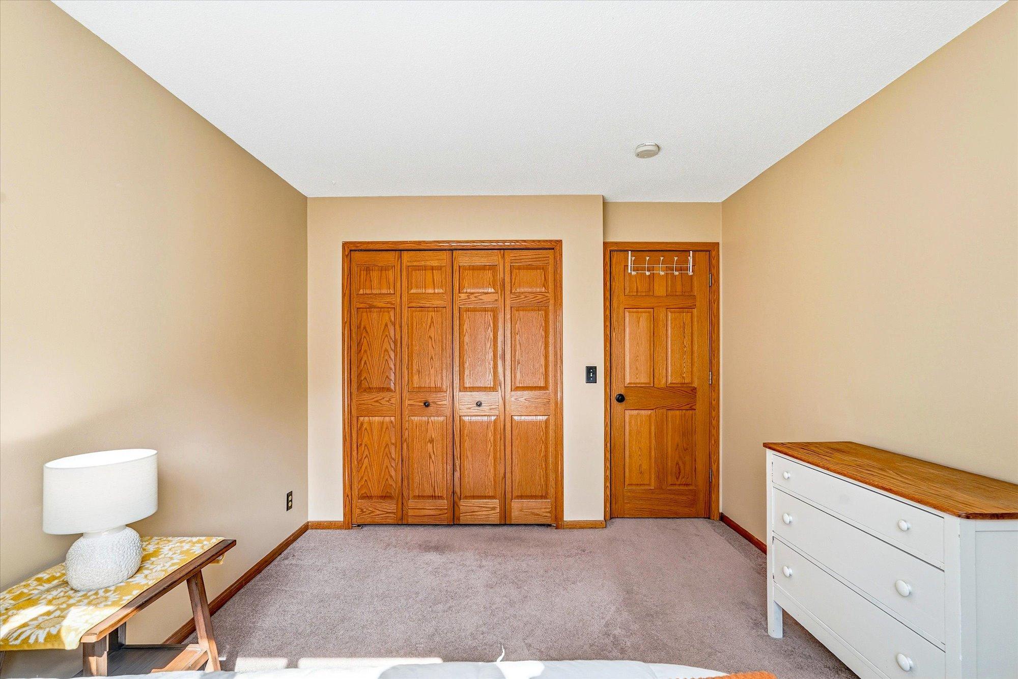 Spacious bedroom featuring solid 6-panel wood doors and ample closet space.