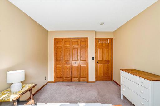 Spacious bedroom featuring solid 6-panel wood doors and ample closet space.