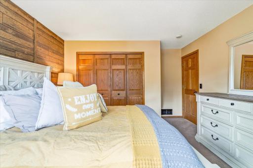 Another view of the spacious primary bedroom showcasing ample closet space and solid wood doors.