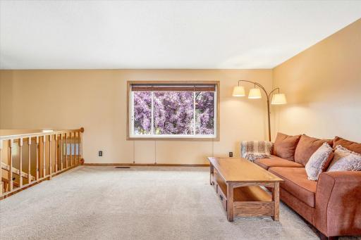 Spacious living room filled with natural light and large front window views overlooking the beautiful flowering crab tree.