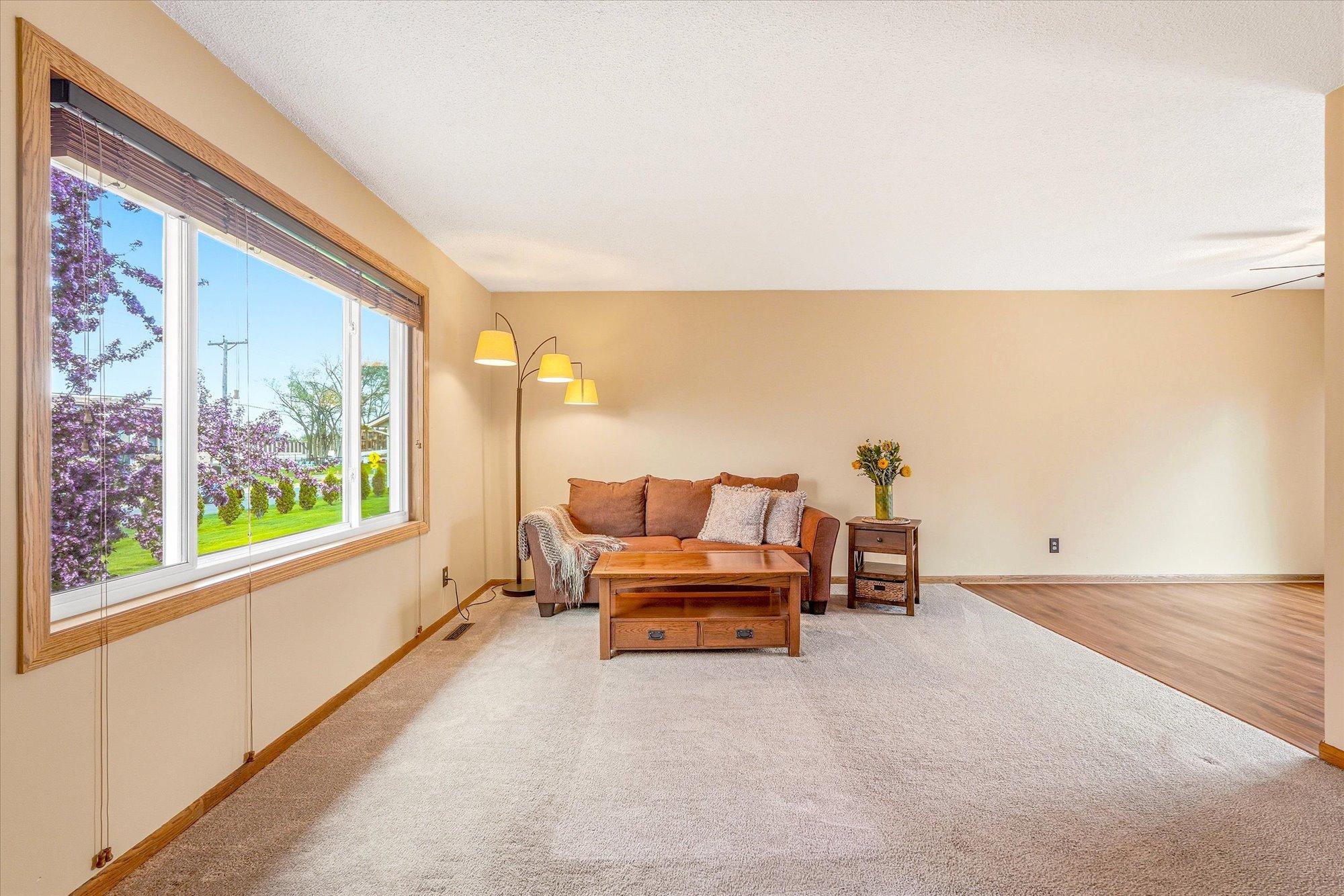 Comfortable main level living space with abundant natural light and an open flow into the dining area.