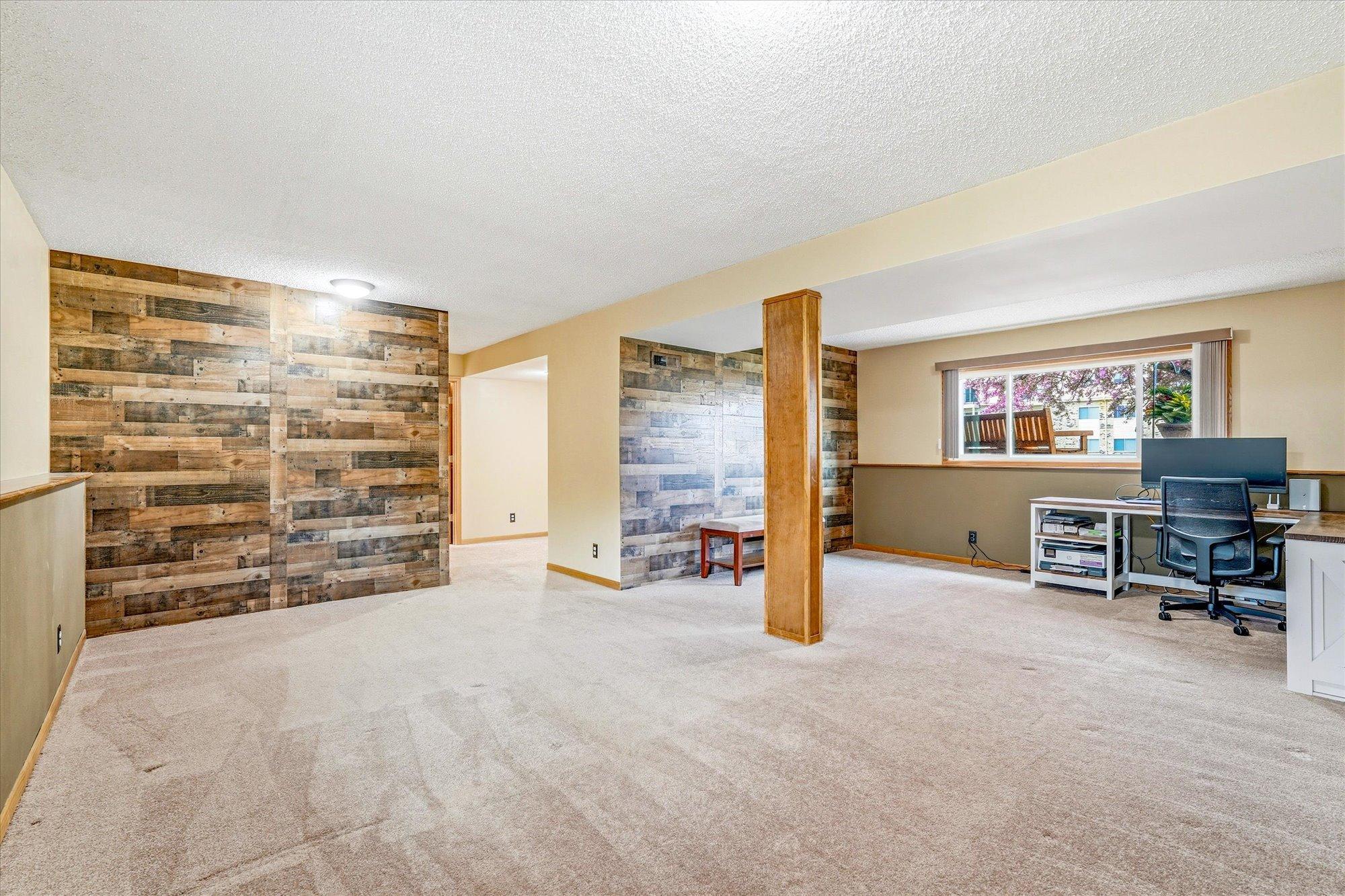 Expansive lower-level family room offers plenty of space for entertaining, recreation, or relaxing.