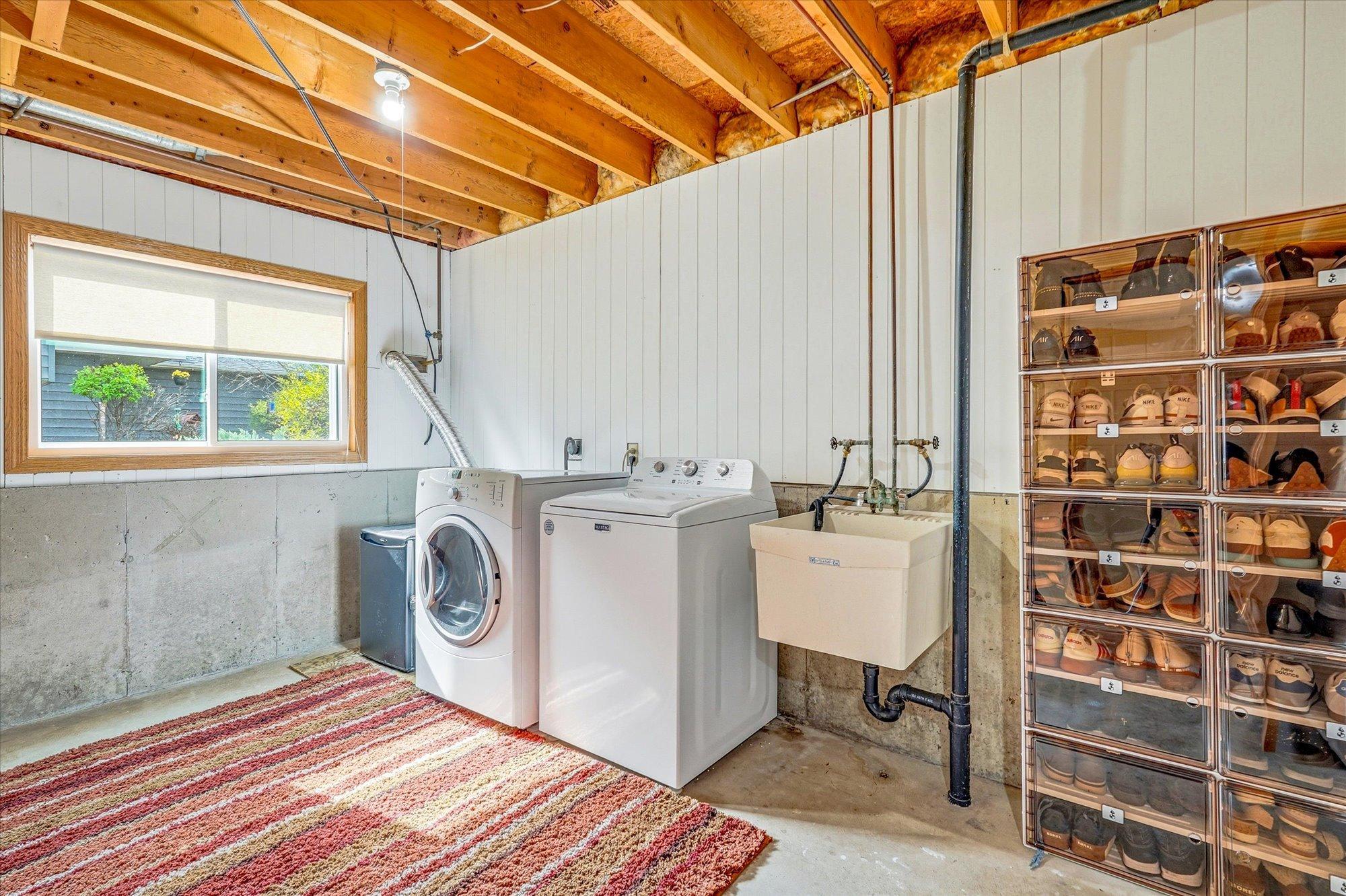 Large laundry and utility room offers abundant storage space, utility sink, and everyday functionality.