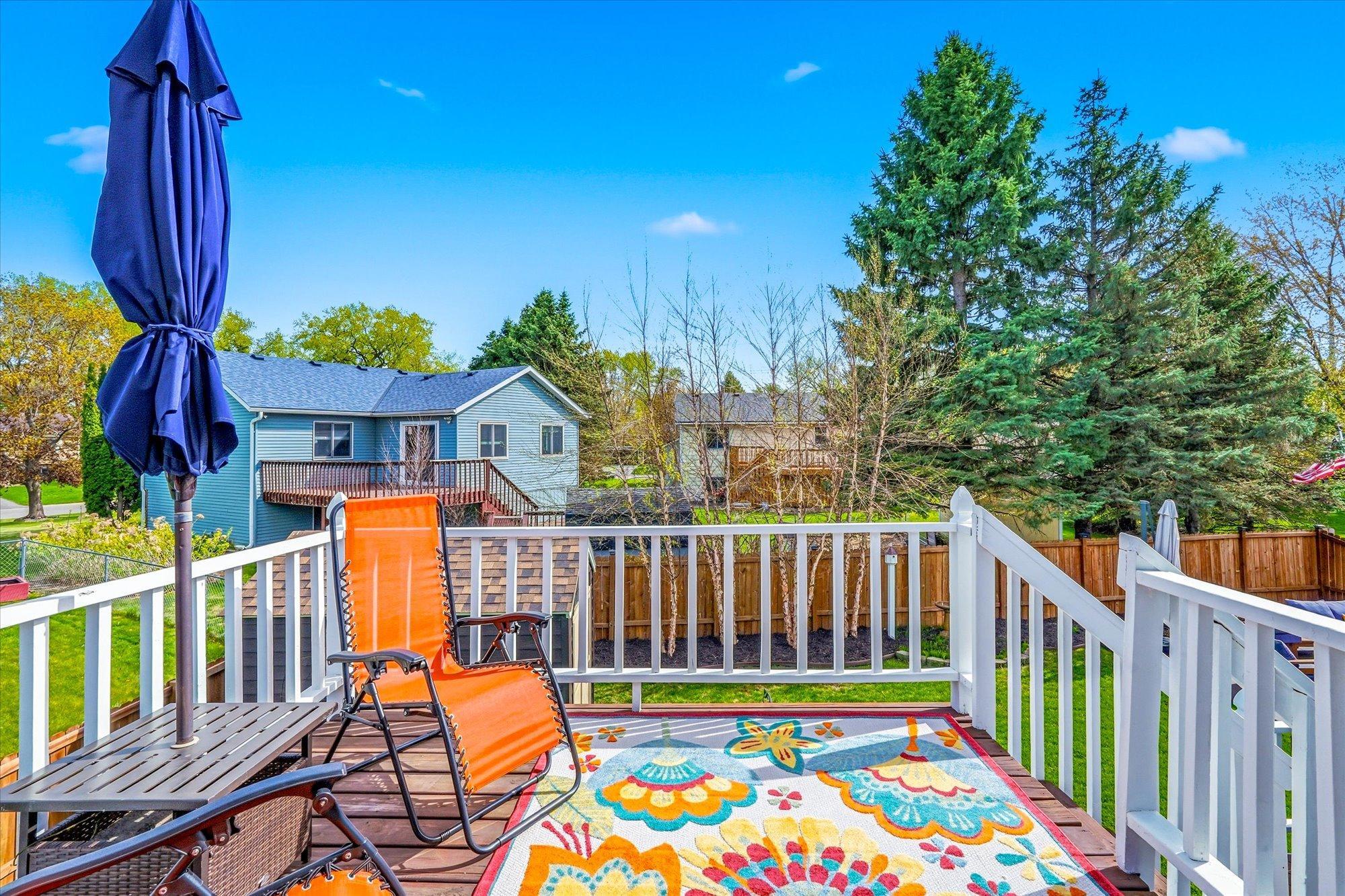 Enjoy relaxing or entertaining on the spacious upper deck overlooking the fenced backyard.