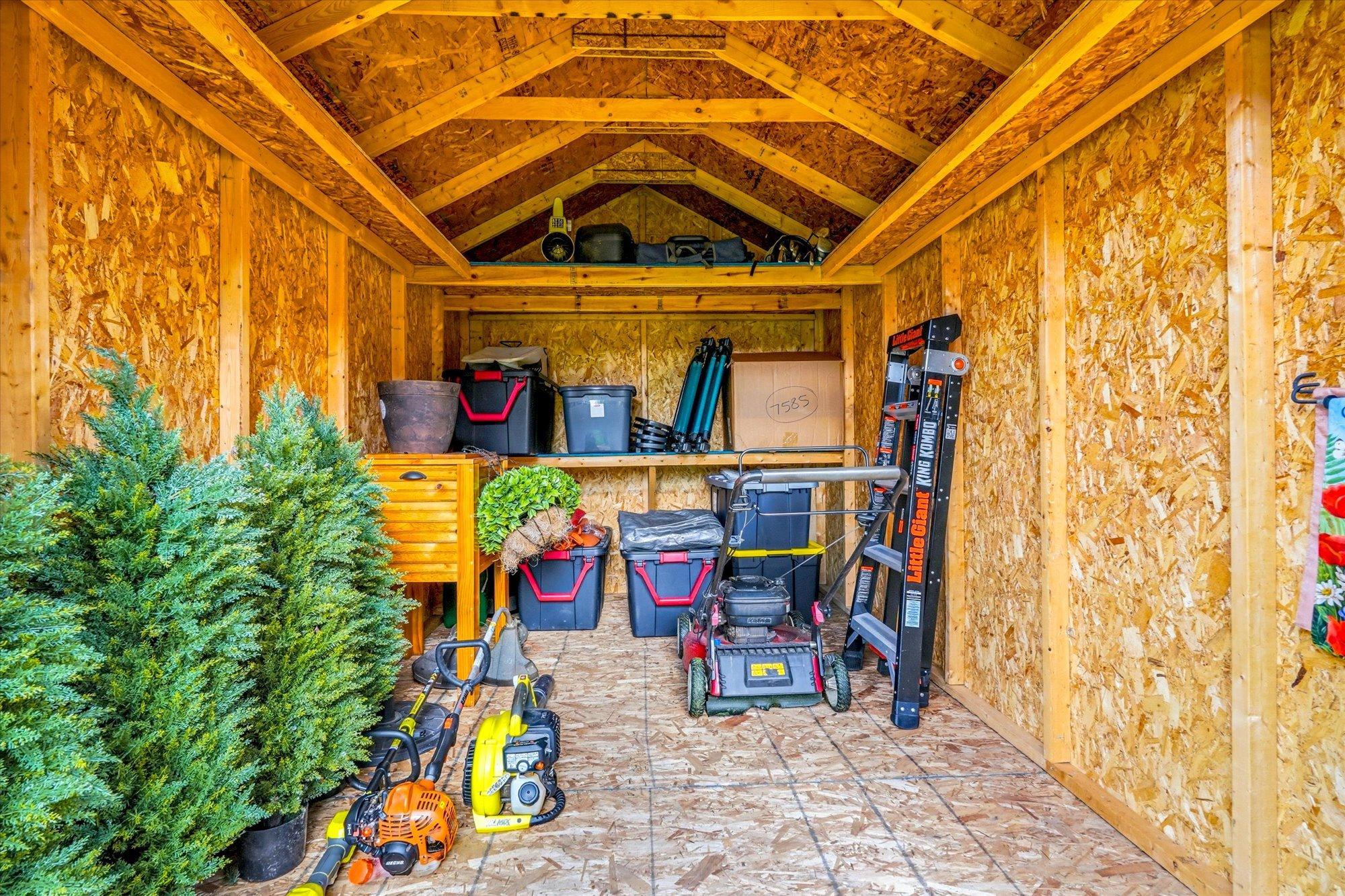 Inside the spacious storage shed with plenty of room for tools, equipment, and seasonal storage.