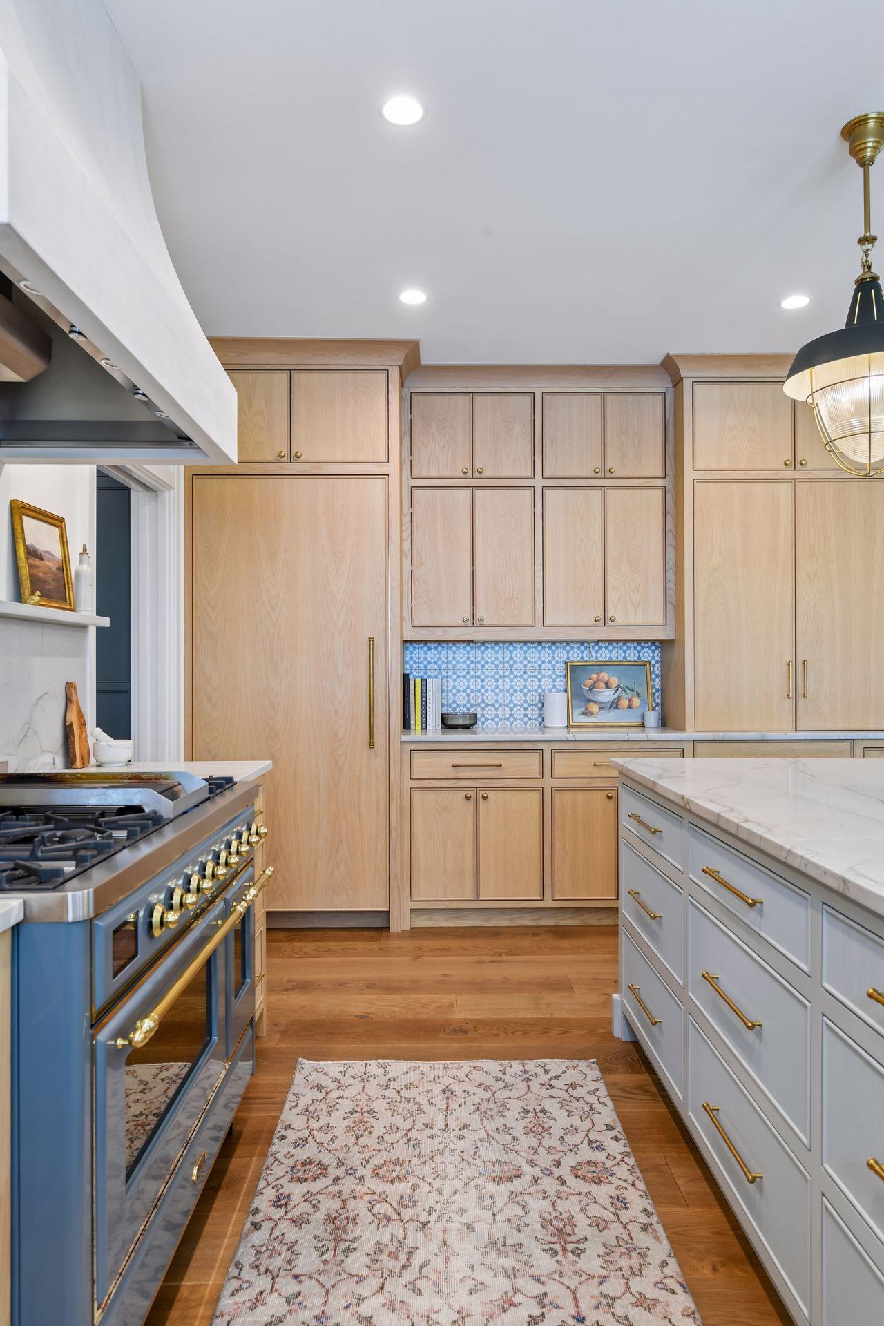 Beautiful custom inset cabinetry hides the sub-zero fridge, freezer drawers, microwave, etc.