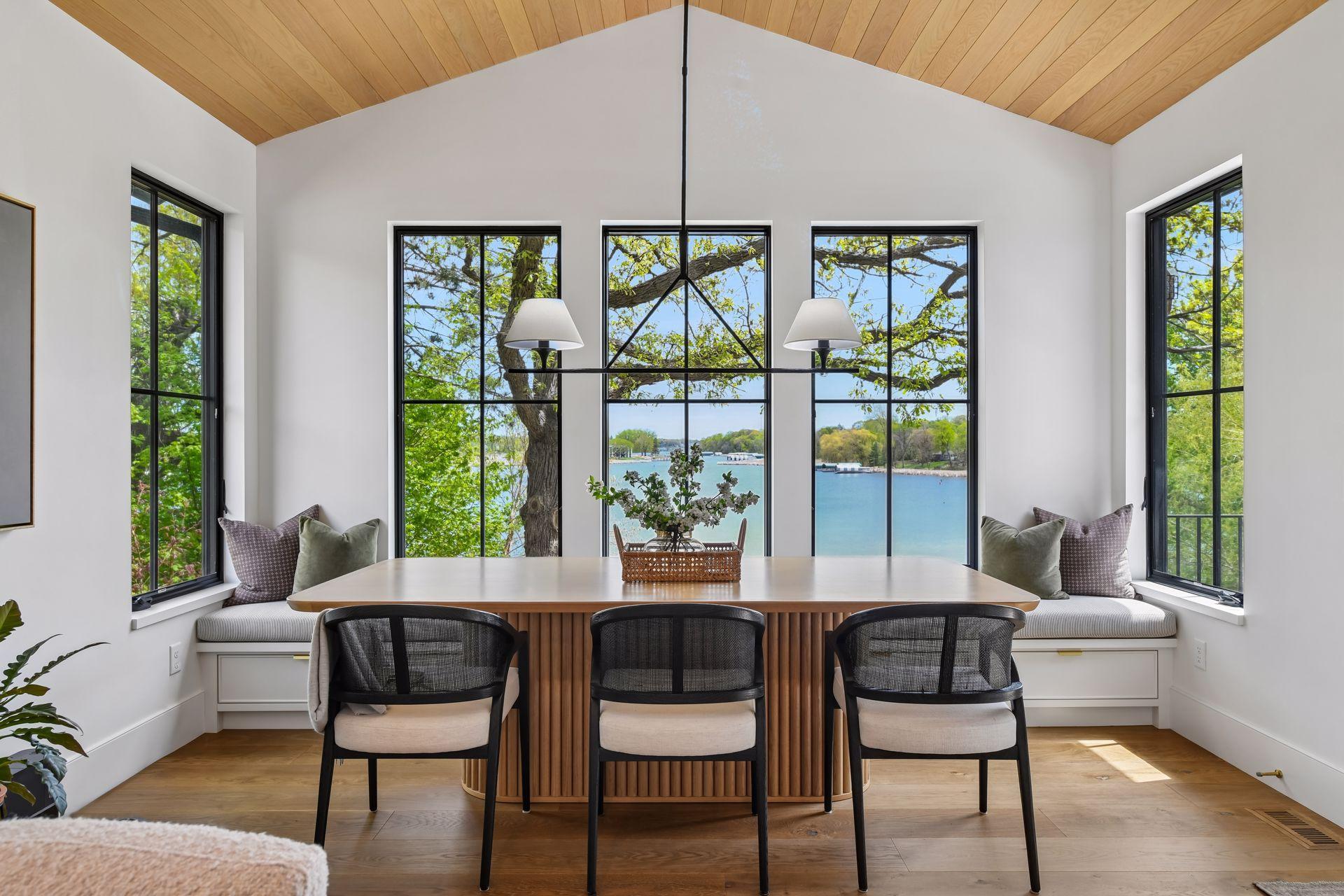 Award-winning dining room is breathtaking. 2nd place 2024 Midwest Design Award for Contemporary Dining. White oak tongue and groove planks on the ceiling. Large windows on all 3 sides of the room. Door conveniently opens to the deck.
