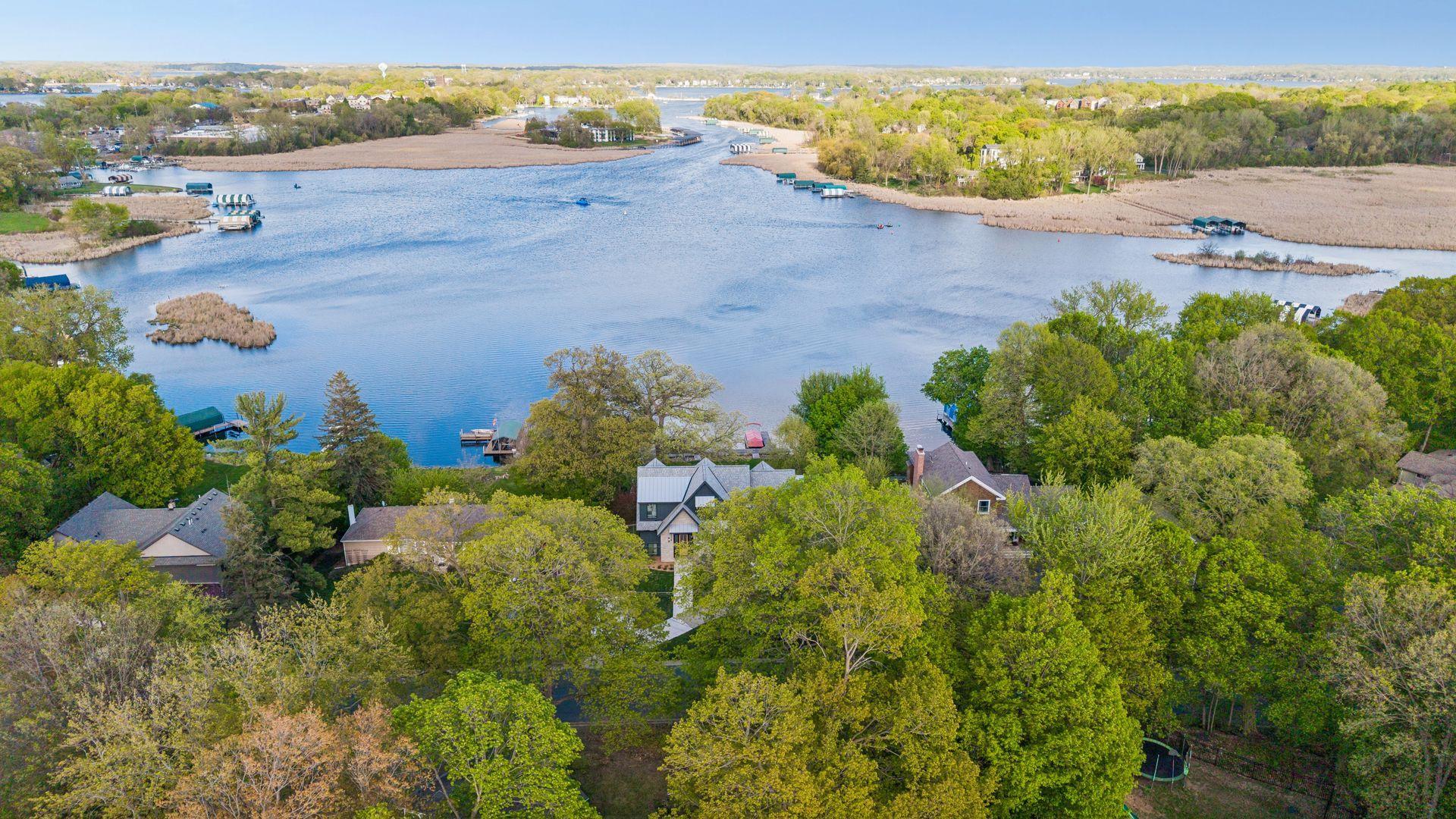 Aerial view of what you see from the rooms in the house. Seton Lake is quiet and perfect for fishing, paddleboarding, kayaking, etc. but still has access to the bigger and busier portions of Lake Minnetonka. One channel is straight ahead.