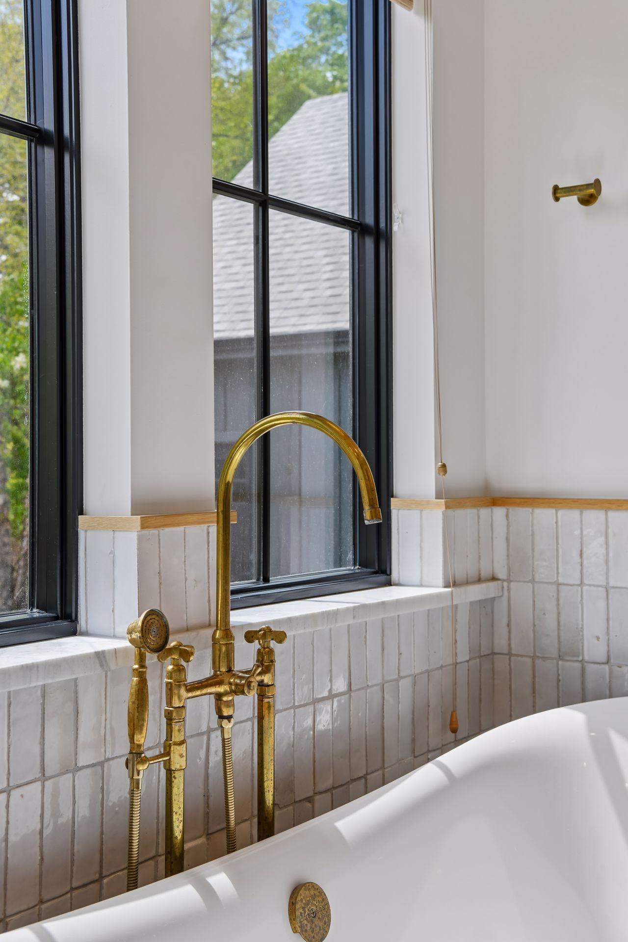 Unlacquered brass faucets from an artisan out of Morocco that patina naturally. Gorgeous handmade tiles. Lovely soaker tub. Heated floor.