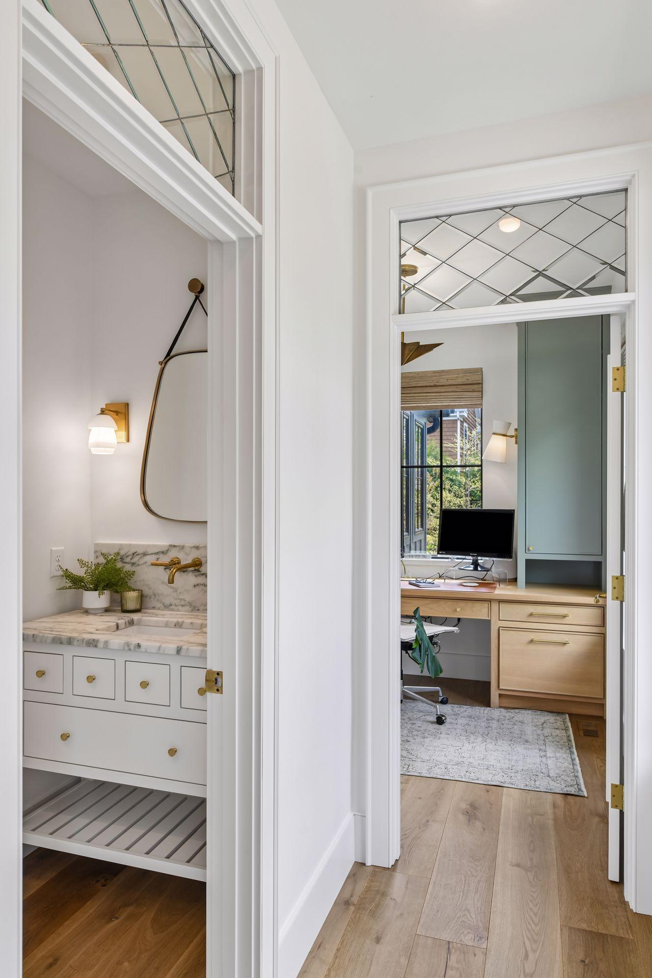 Front hall leads to the powder room and office. These rooms are away from the hub of the home, offering more solitude and privacy. Check out the transom windows, which is perfect for bringing light into the powder room.