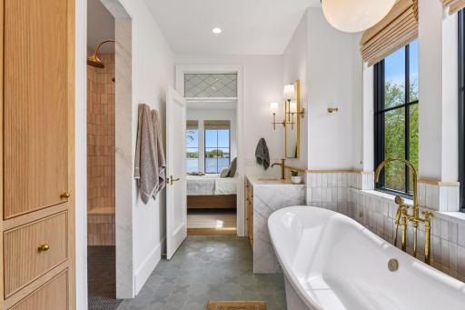Windows from all sides offering natural light. Walk-in shower with dual shower heads and handmade tile. Linen closet. Reeding on the separate vanities and cabinets. Marble waterfall countertops.