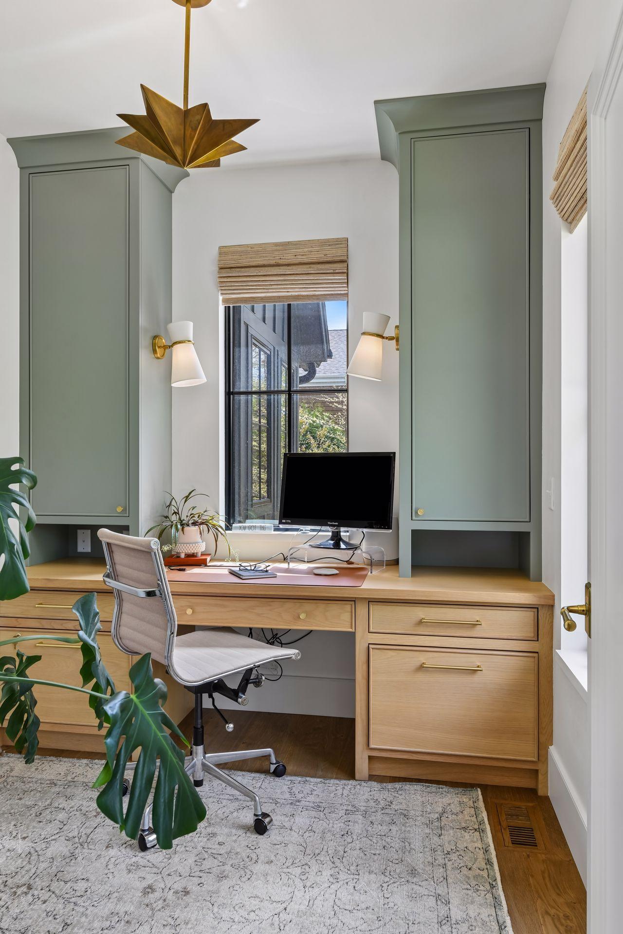 Main floor office is tucked away from the center of the house, offering privacy. Two windows fill the room with light. This room is so cheery, work will be fun! Custom cabinets and light fixtures.