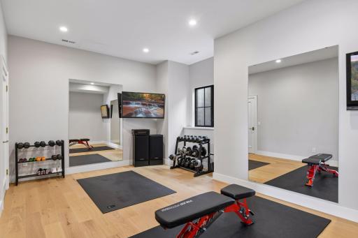 Lower level gym with space for 2 to workout together, includes 2 TVs. The floor has a commercial grade shock absorption system underneath. This room has an egress window and a closet in case you need it to be your 5th bedroom.