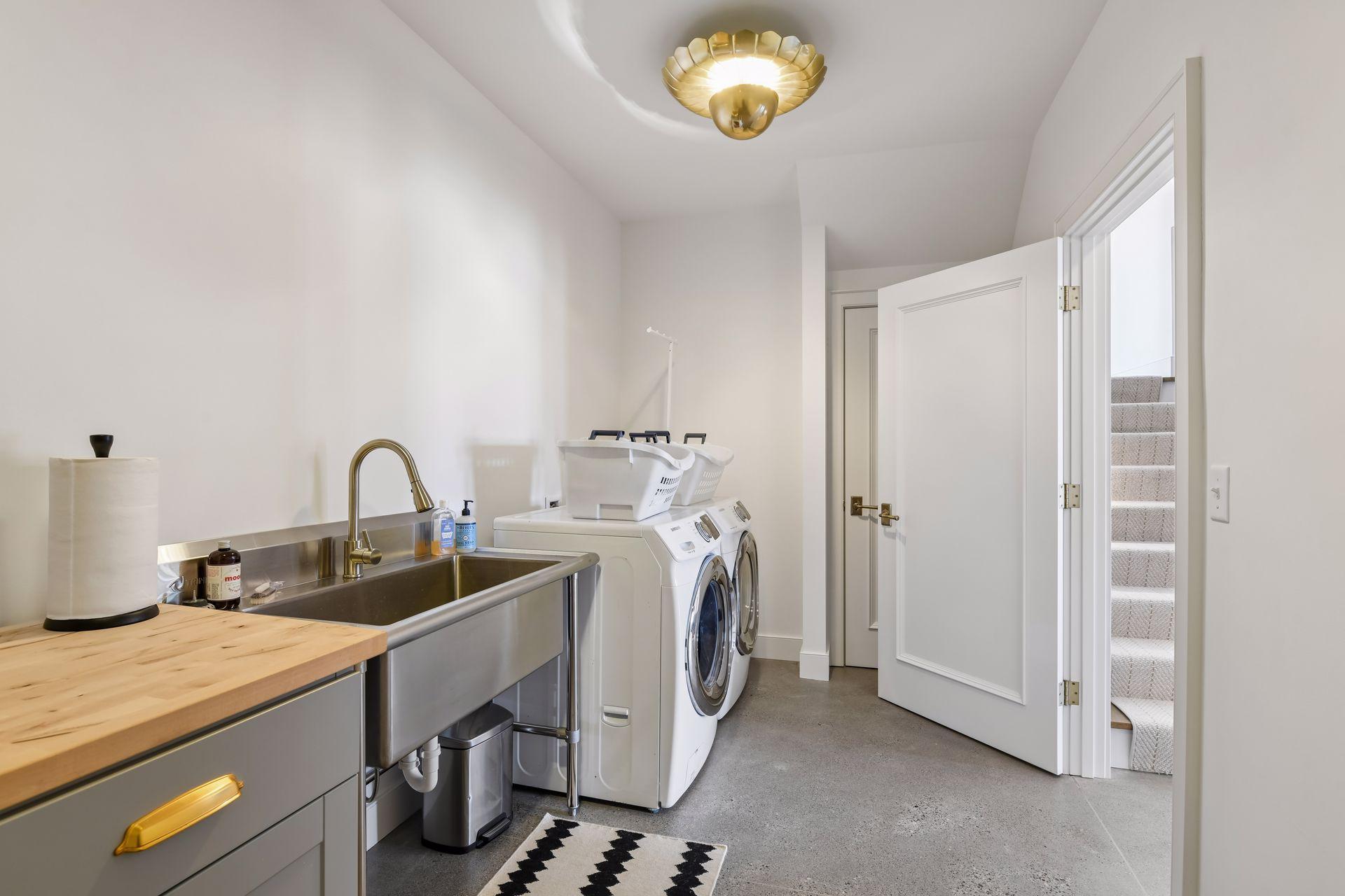 Lower-level 2nd laundry with commercial grade sink and storage. Perfect for washing things as you come in off the lake. TruStile solid wood doors throughout the home.