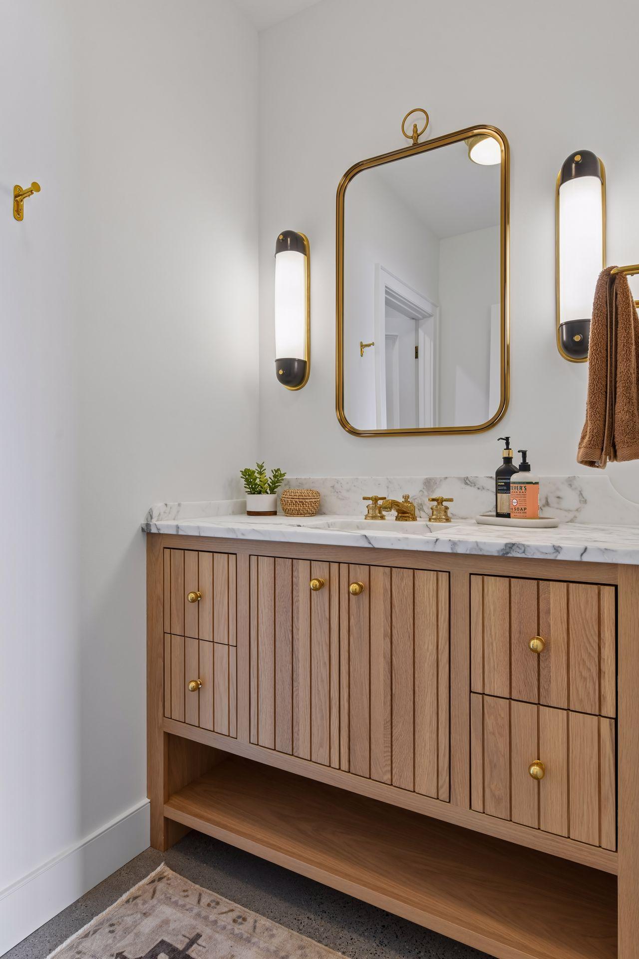 Lower-level 1/2 bath can be converted to a 3/4 bath by opening the wall opposite this vanity. Design plans and selections are available.