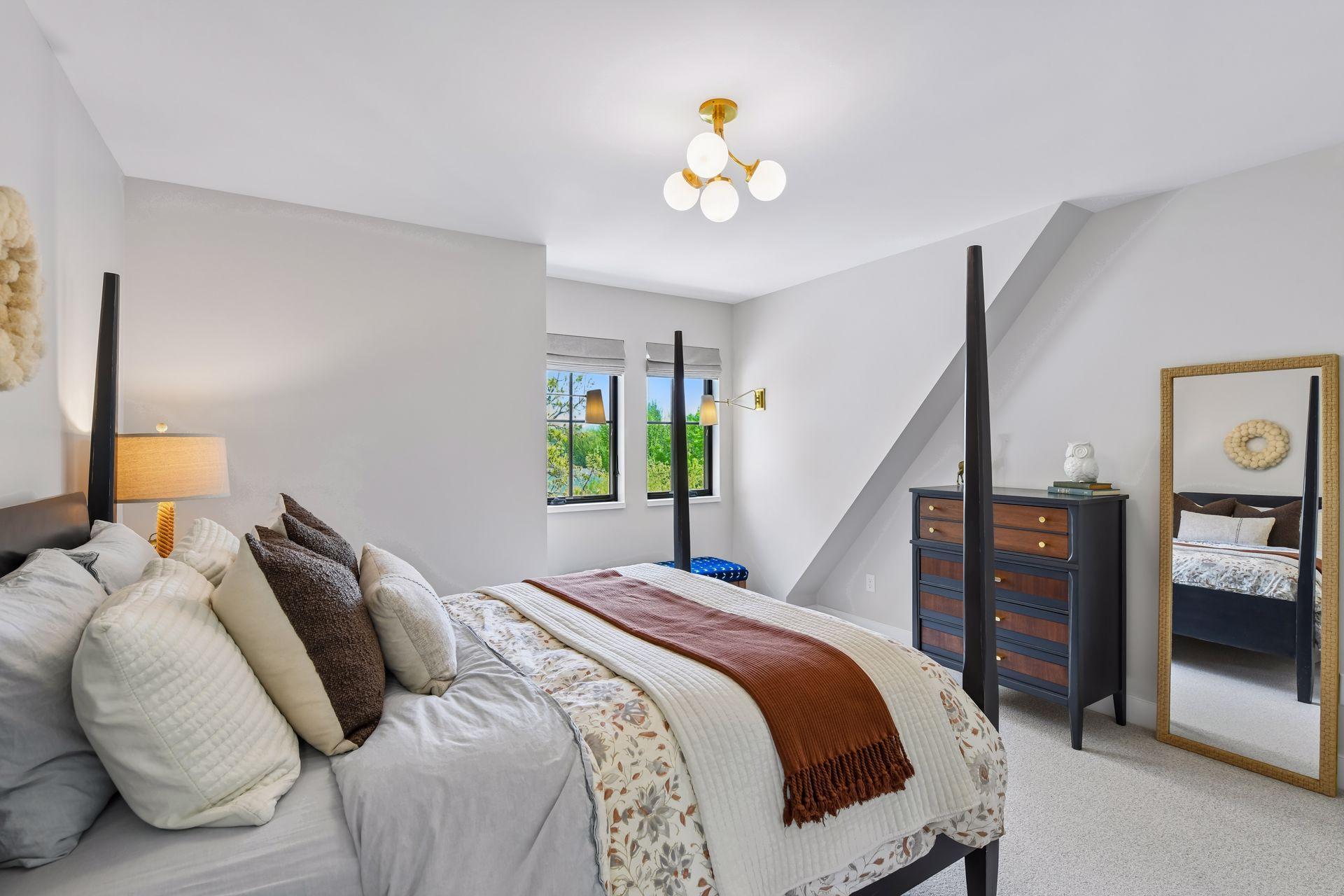 One of 2 upper level bedrooms. Spacious with a walk-in closet. The fun sconces provide an opportunity for a reading nook or homework spot under the window.
