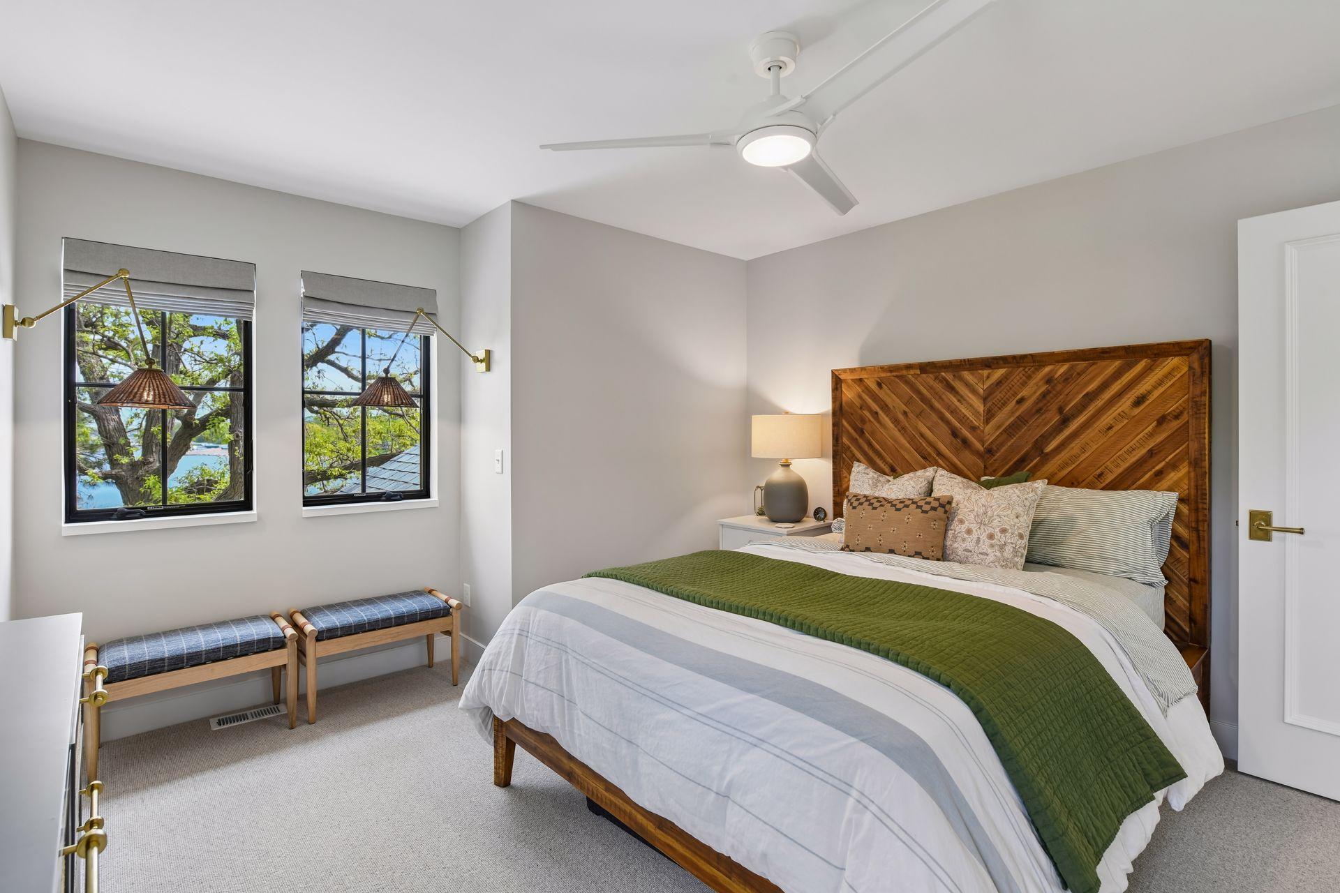 The upper level is zoned separately for heating and cooling, making it easy to close off if no one is staying here. Bedroom 2 on the upper level is large. The fun sconces in the dormer allow for a spot to read or do homework.