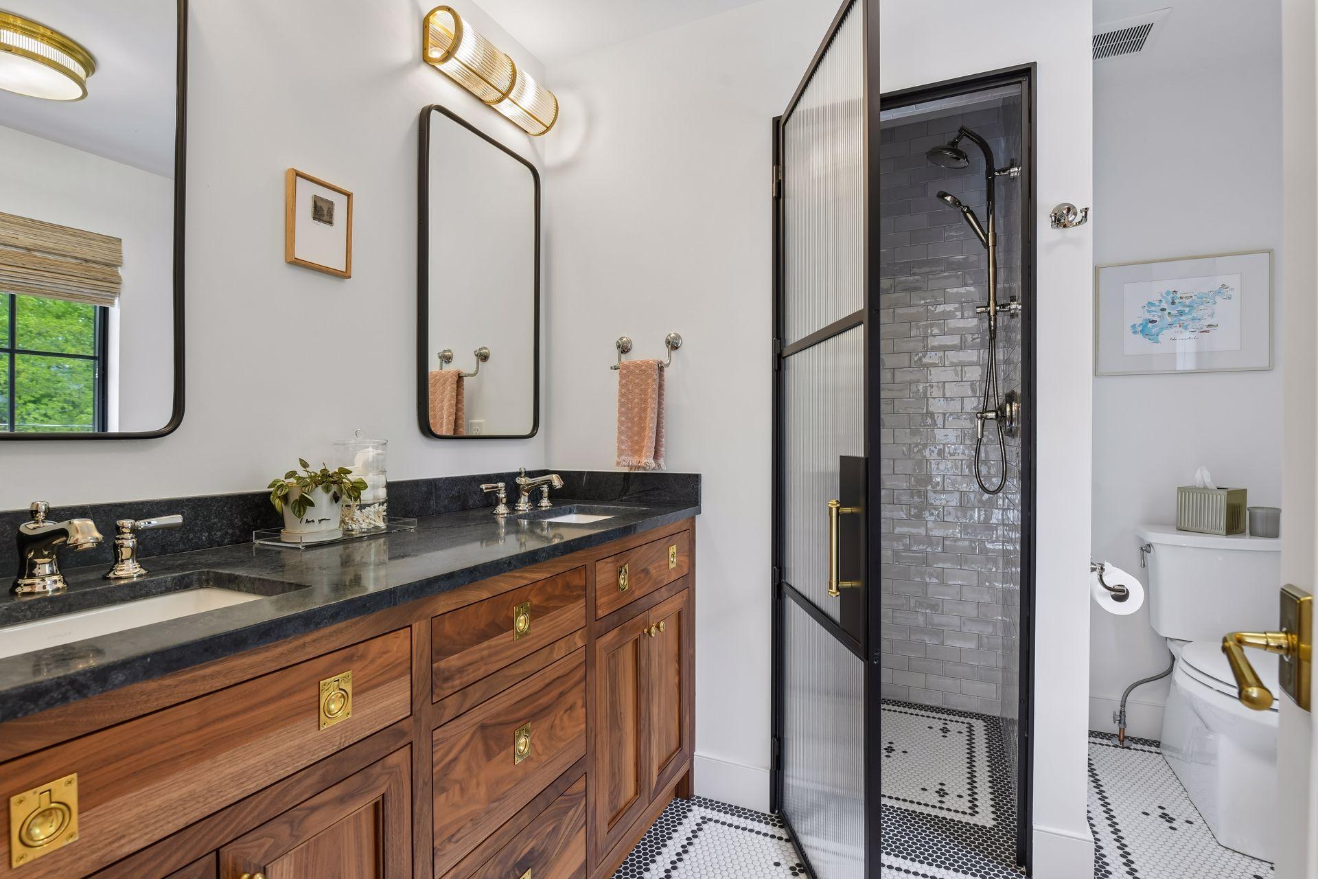 Upper level 3/4 bath with dual sink vanity. The tile is a work of art. This room also includes a window and a linen closet.