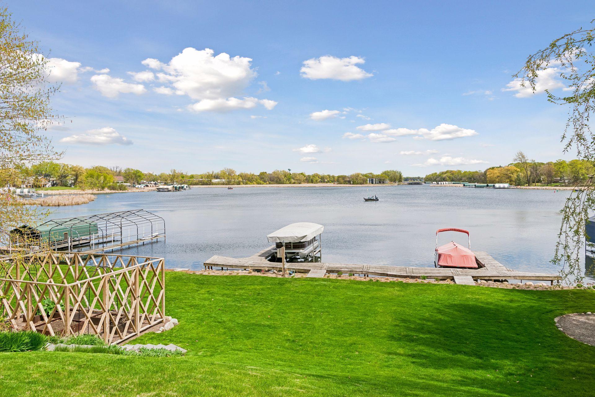Enjoy 100 feet of lakeshore. The dock and lift are permanent and included in the sale. The 2 slips can park 4 boats. The slip on the right has been rented for several years. Pontoon on the left is for sale.