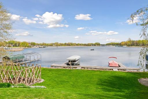 Enjoy 100 feet of lakeshore. The dock and lift are permanent and included in the sale. The 2 slips can park 4 boats. The slip on the right has been rented for several years. Pontoon on the left is for sale.
