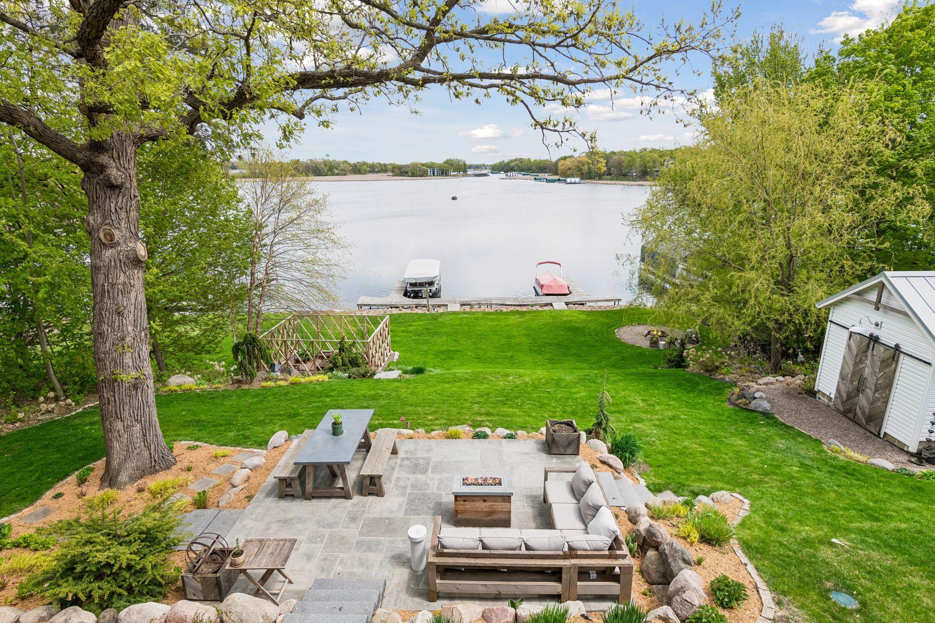 The beautiful paver patio is expansive and just one more space to relax or entertain. The dock can hold 4 boats on 2 slips. The fenced garden protects your treasures from deer. Shed with metal roof and potting shed in back.
