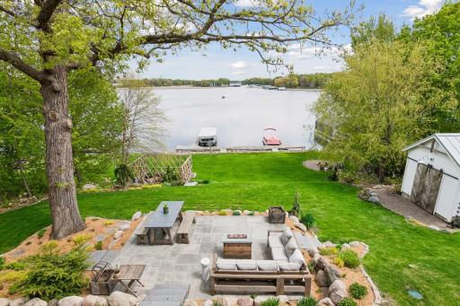 The beautiful paver patio is expansive and just one more space to relax or entertain. The dock can hold 4 boats on 2 slips. The fenced garden protects your treasures from deer. Shed with metal roof and potting shed in back.