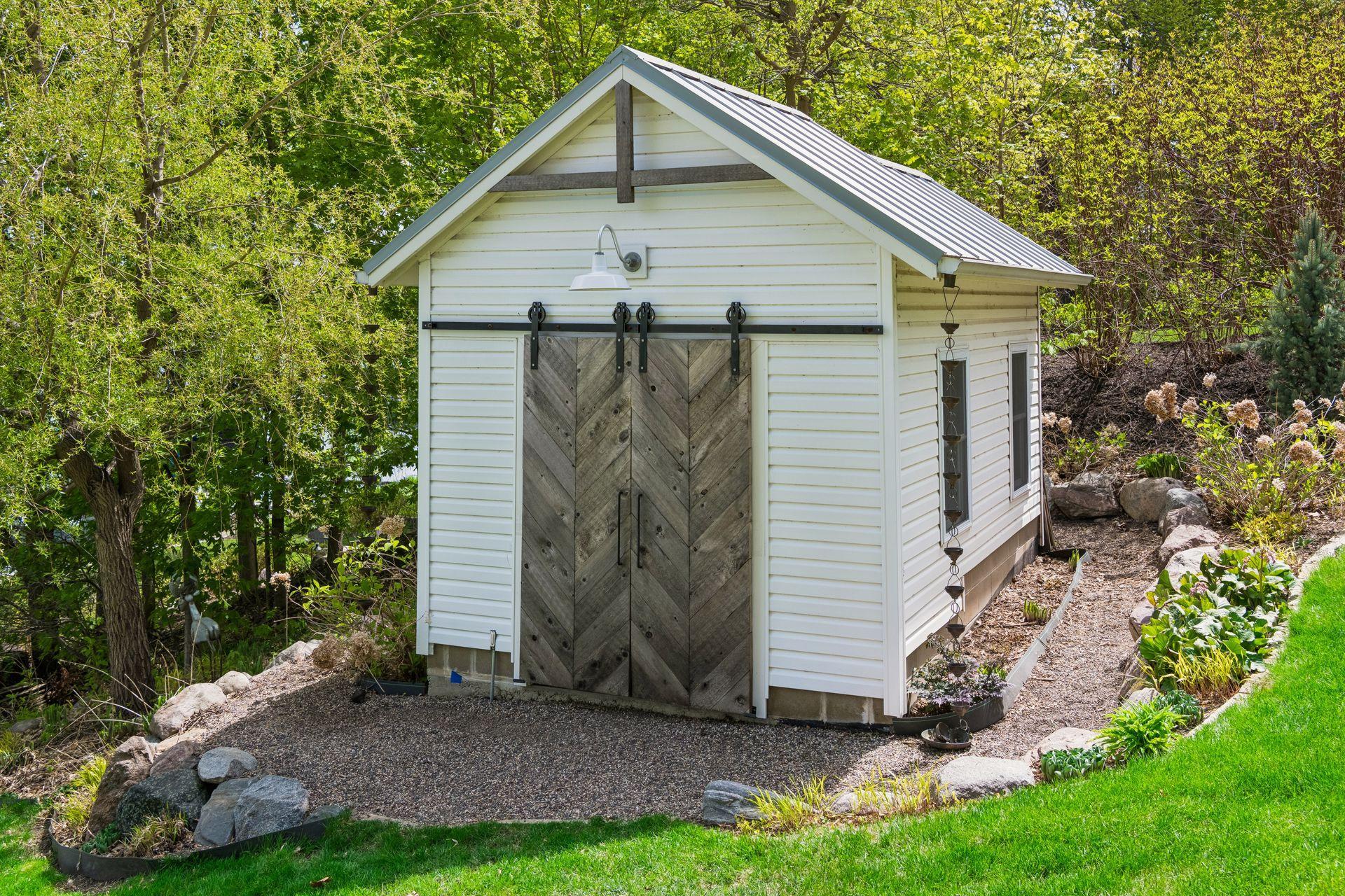 Storage shed with metal roof. There is a separate potting shed with its own entry at the back.
