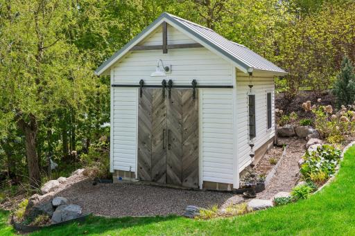 Storage shed with metal roof. There is a separate potting shed with its own entry at the back.
