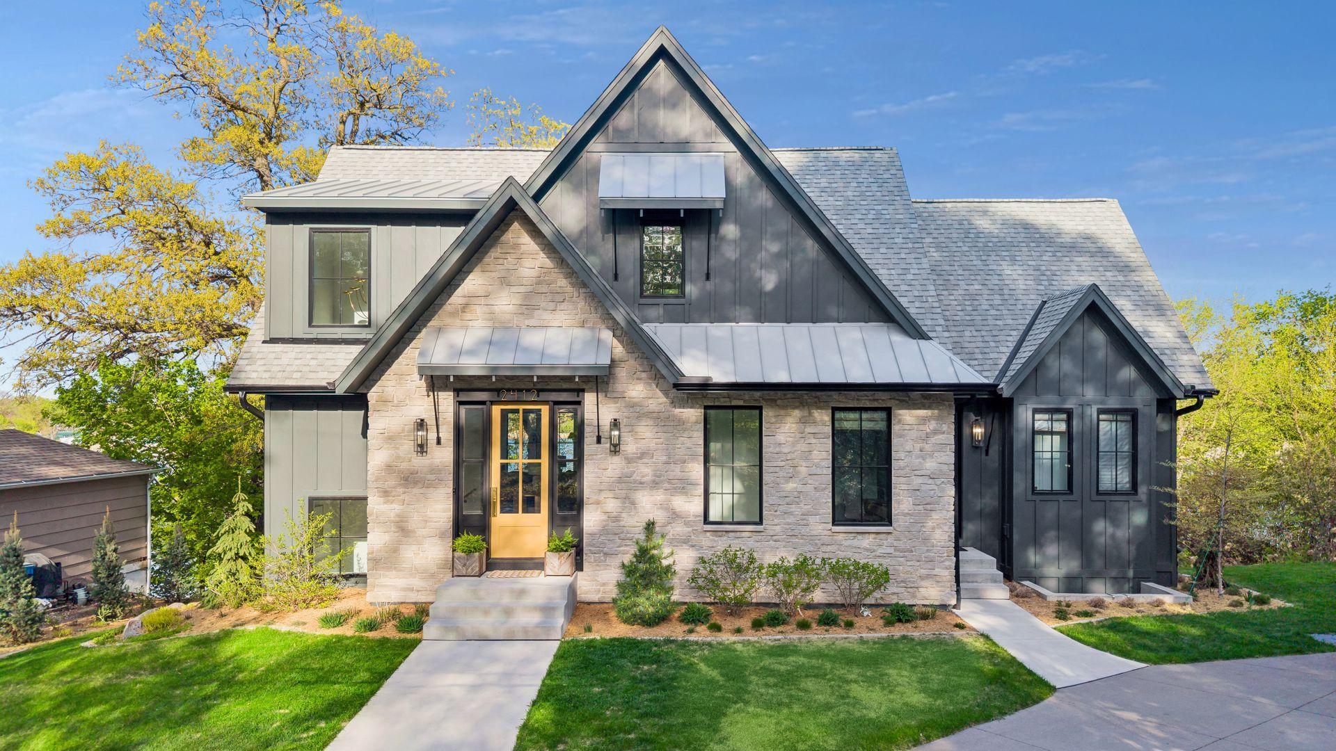 Classic and welcoming exterior with stone, metal and hardi board. 2nd entrance on the right from the mud room leads to the garage.