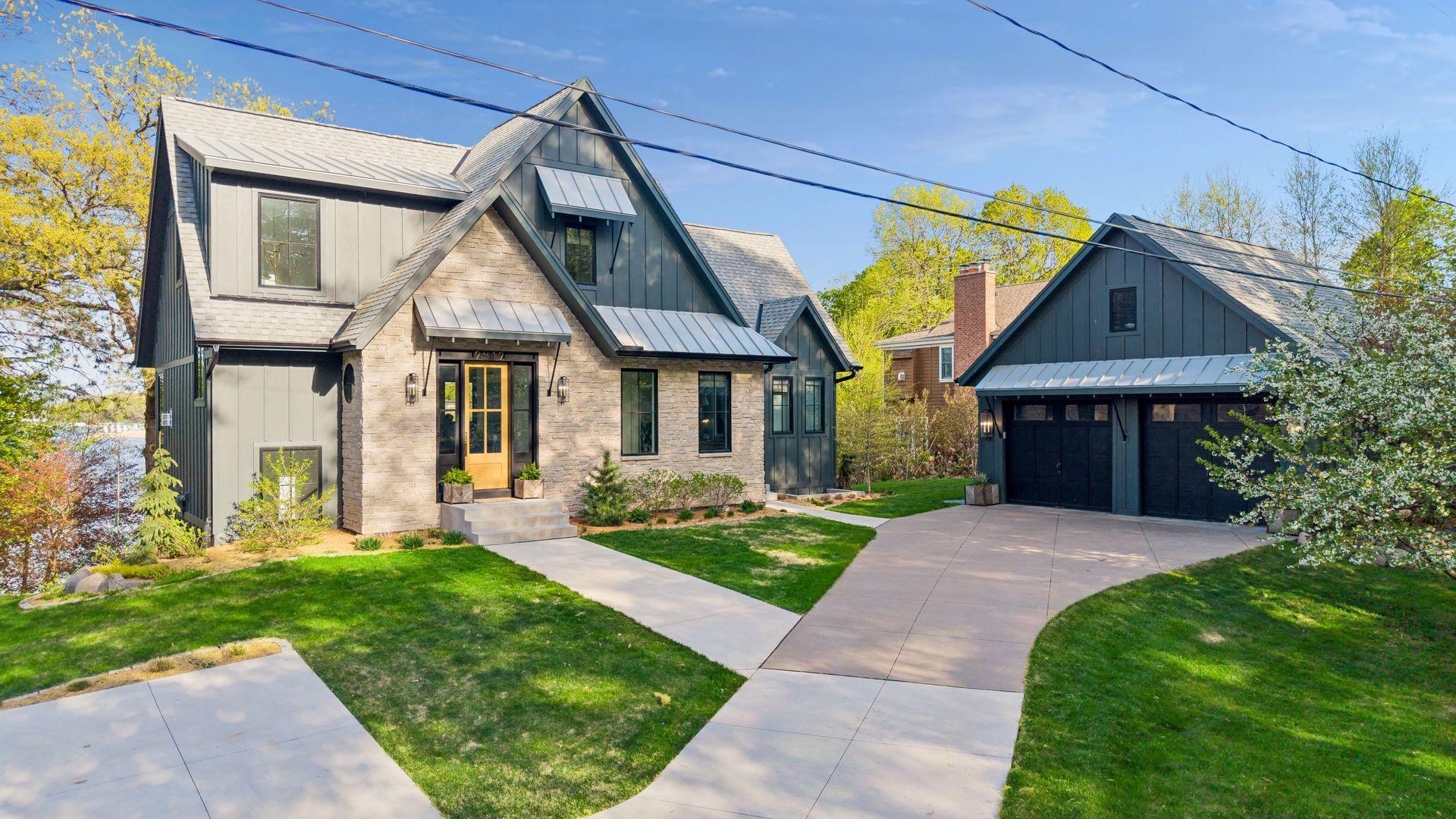 2-car garage with loft, storage space and EV charger. The garage was built in 2013 by the builder of the house. They replaced the roof, siding and windows when the house was built to match the house. Extra parking pad on the left.