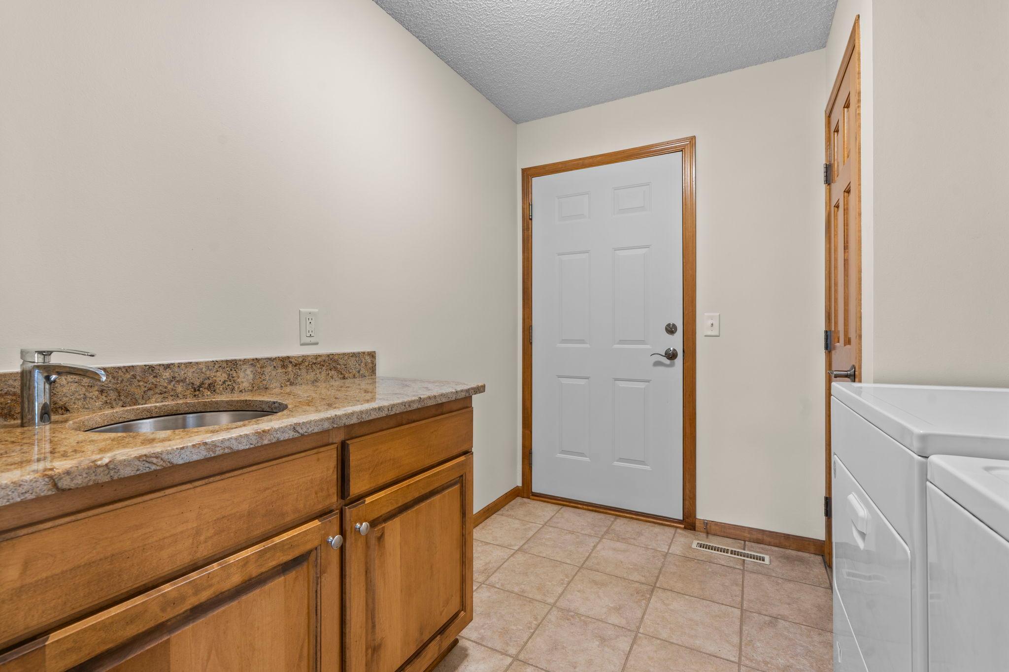 Mudroom / laundry located just off the kitchen and easily accessible from garage.