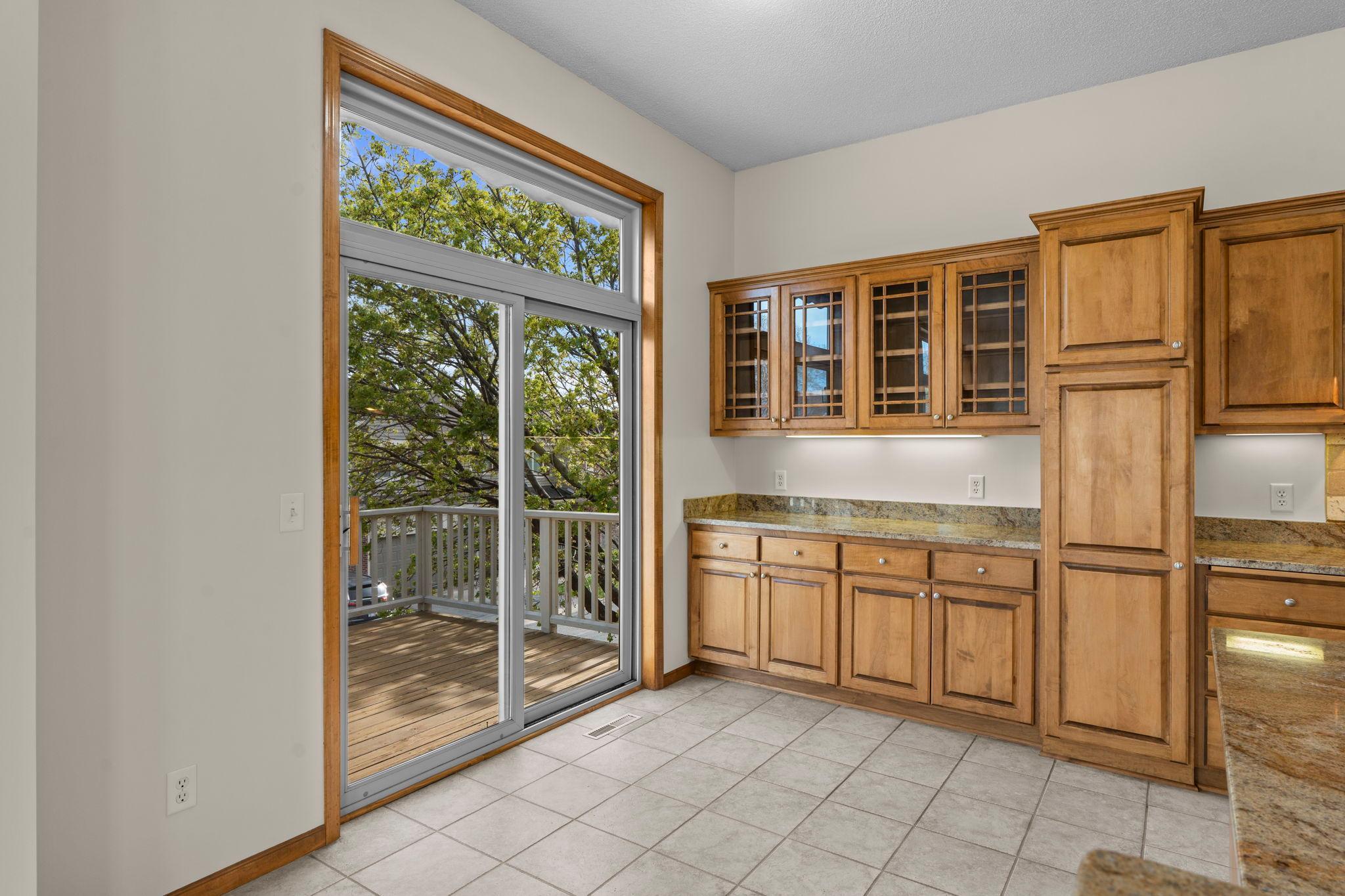 Walkout from kitchen to private deck. Large patio door brings in a ton of natural light.