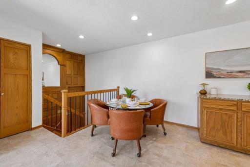 Custom solid wood panel wall with one of a kind mirror. Doorway leads to the hallway that is connected to the garage.