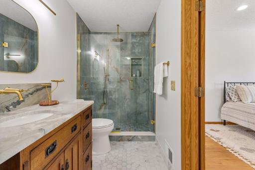 The main level bathroom can be accessed from the hallway and primary bedroom.