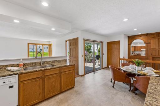 The main level offers an open concept layout with living room, kitchen, and informal dining area.