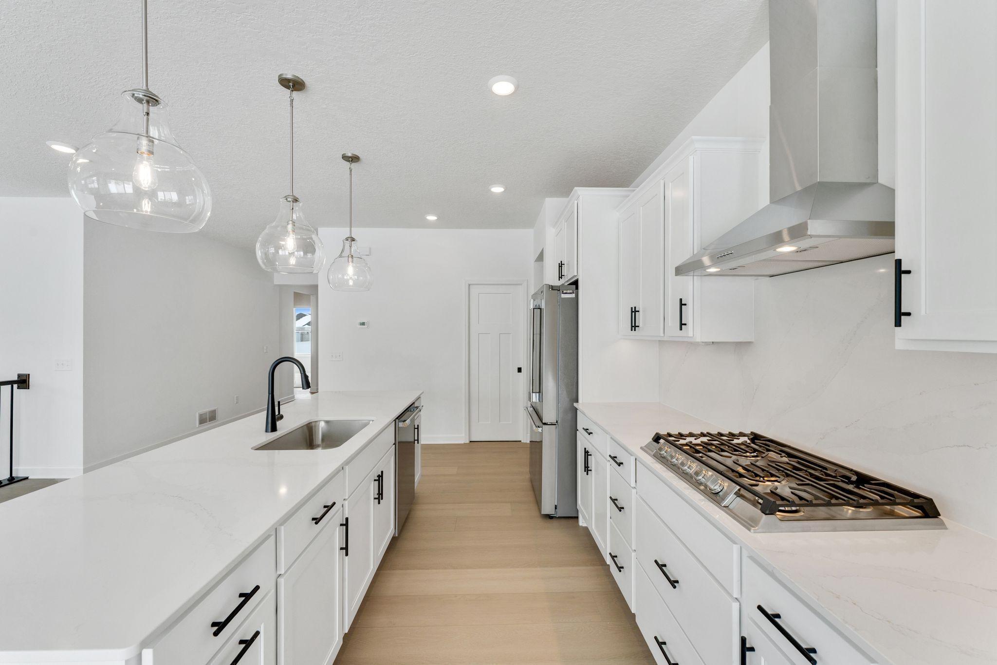 (Photo of a similar home, actual finishes may vary) The kitchen naturally operates as the heart of this home, offering ample countertop space and brand-new appliances that will inspire attempts at new recipes.