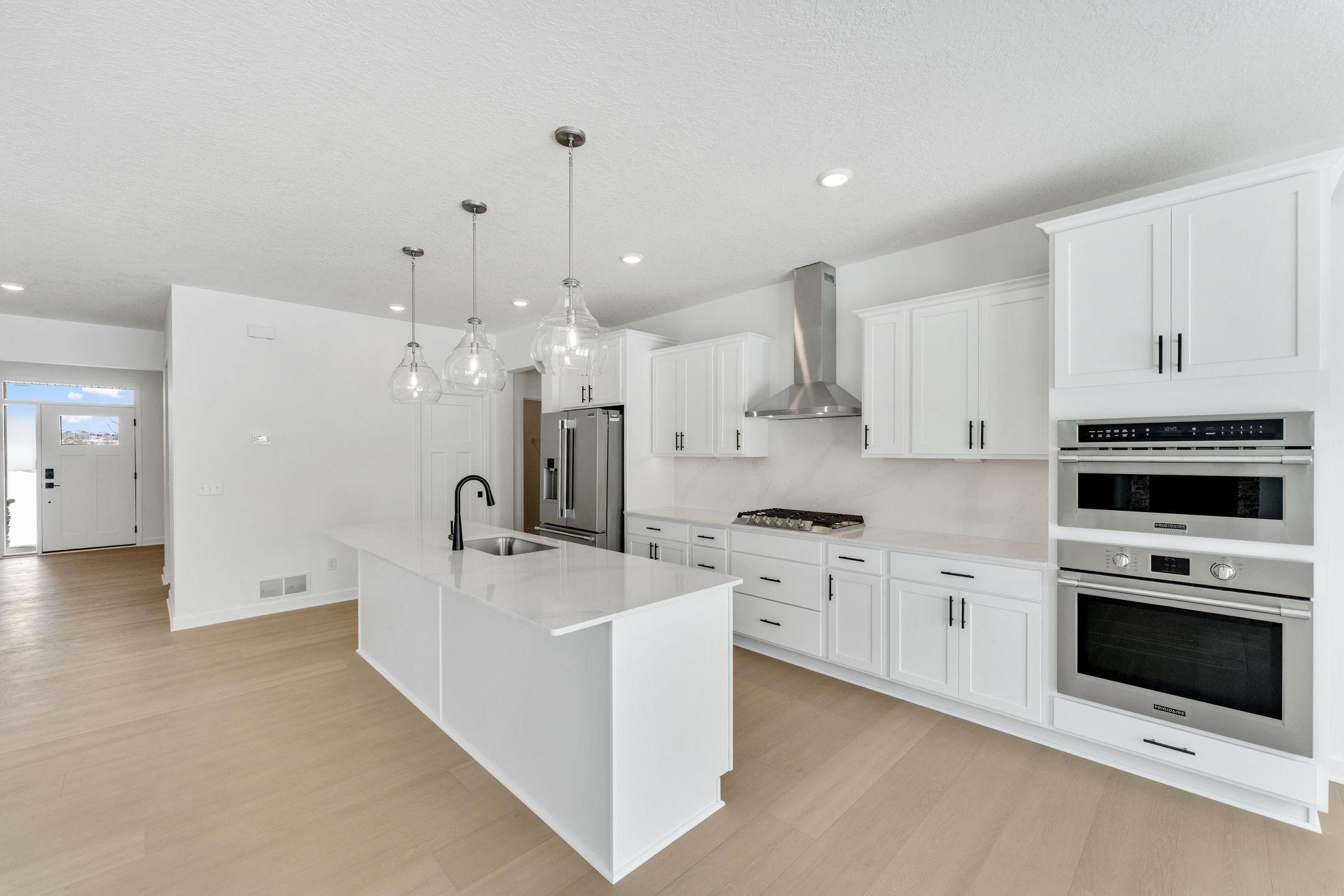 (Photo of a similar home, actual finishes may vary) Elevate culinary creations with cutting-edge stainless steel double wall ovens, designed for precision and performance