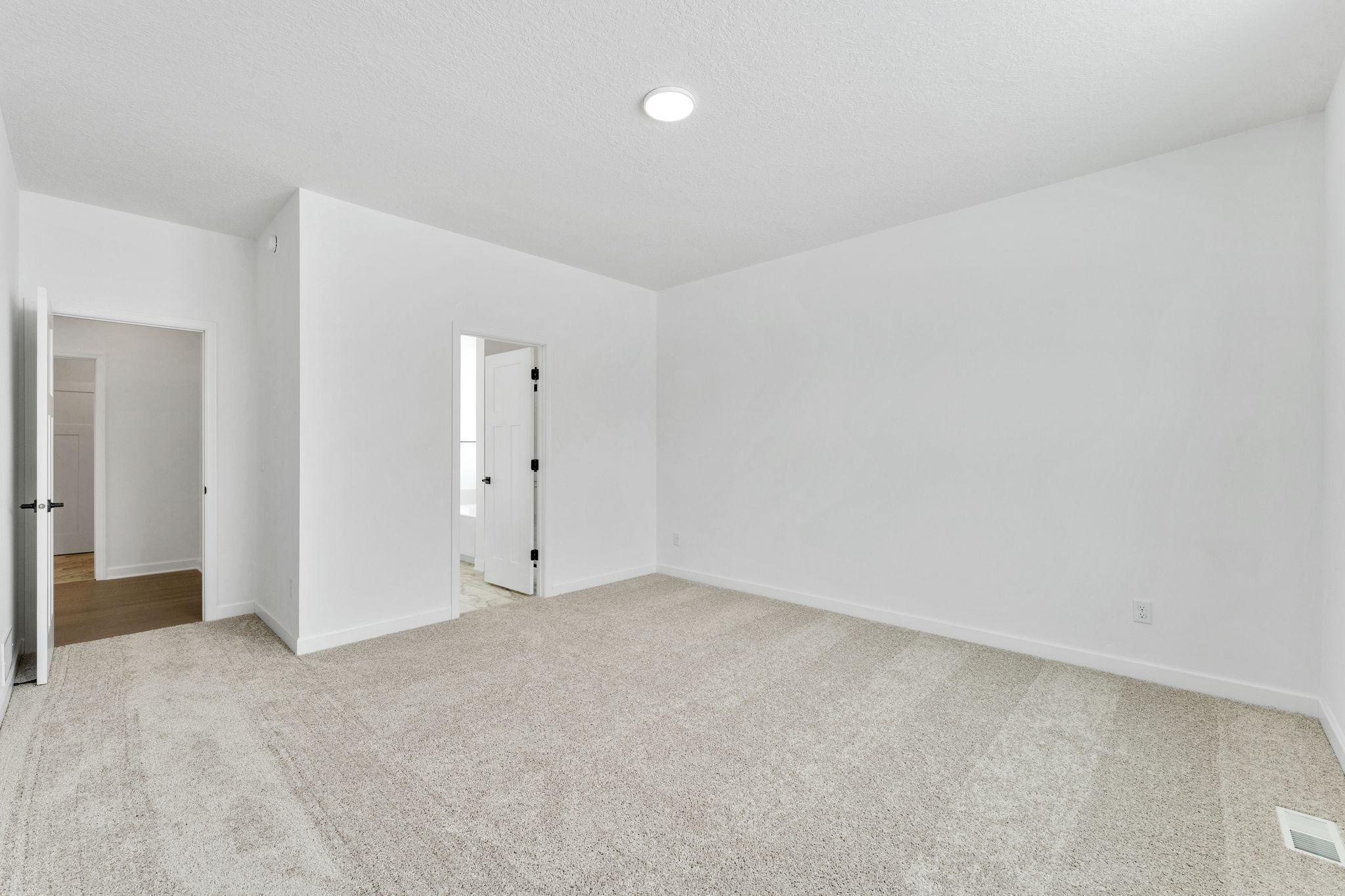 (Photo of a similar home, actual finishes may vary) The owner’s suite is complete with a cozy bedroom, an ensuite bathroom and a walk-in closet.