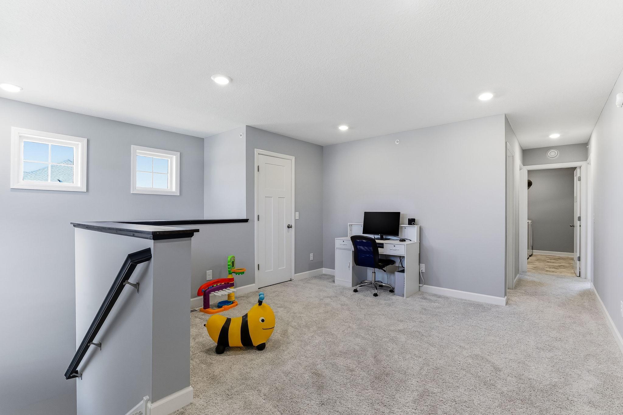 A spacious upper loft offers the flexibility to be used as a private office or a dedicated media room.