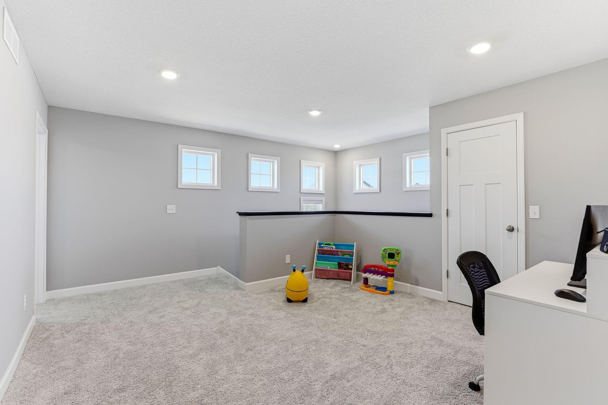 A spacious upper loft offers the flexibility to be used as a private office or a dedicated media room.