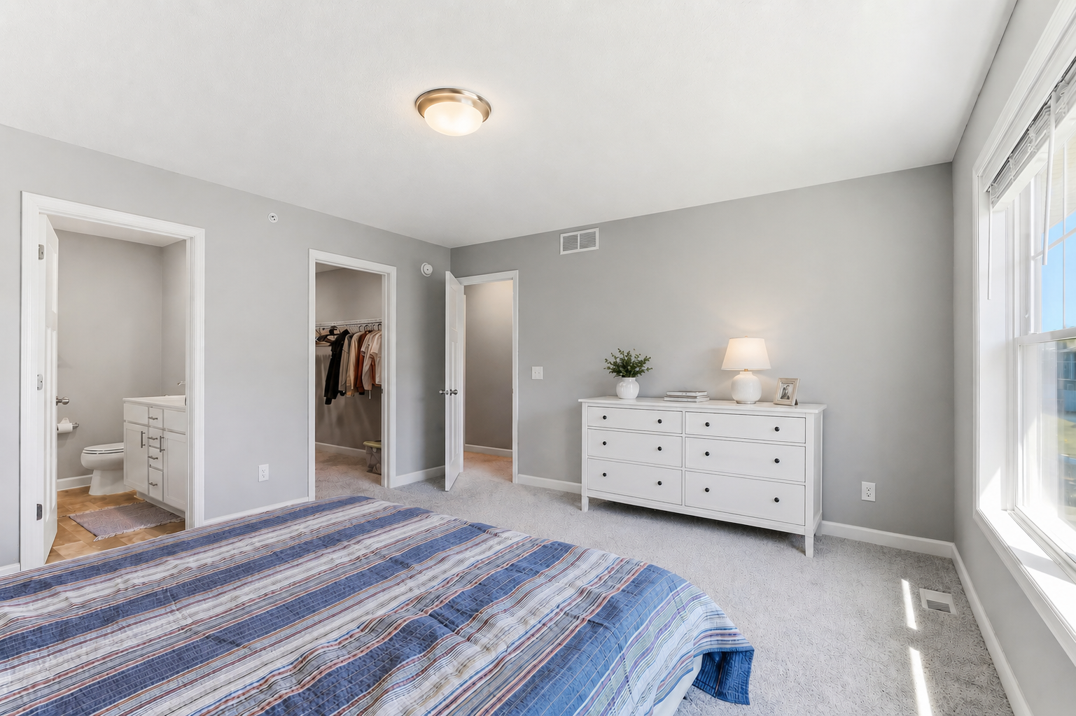 Master bedroom features a generous walk-in closet and a private ensuite bath (contains digital staged elements).