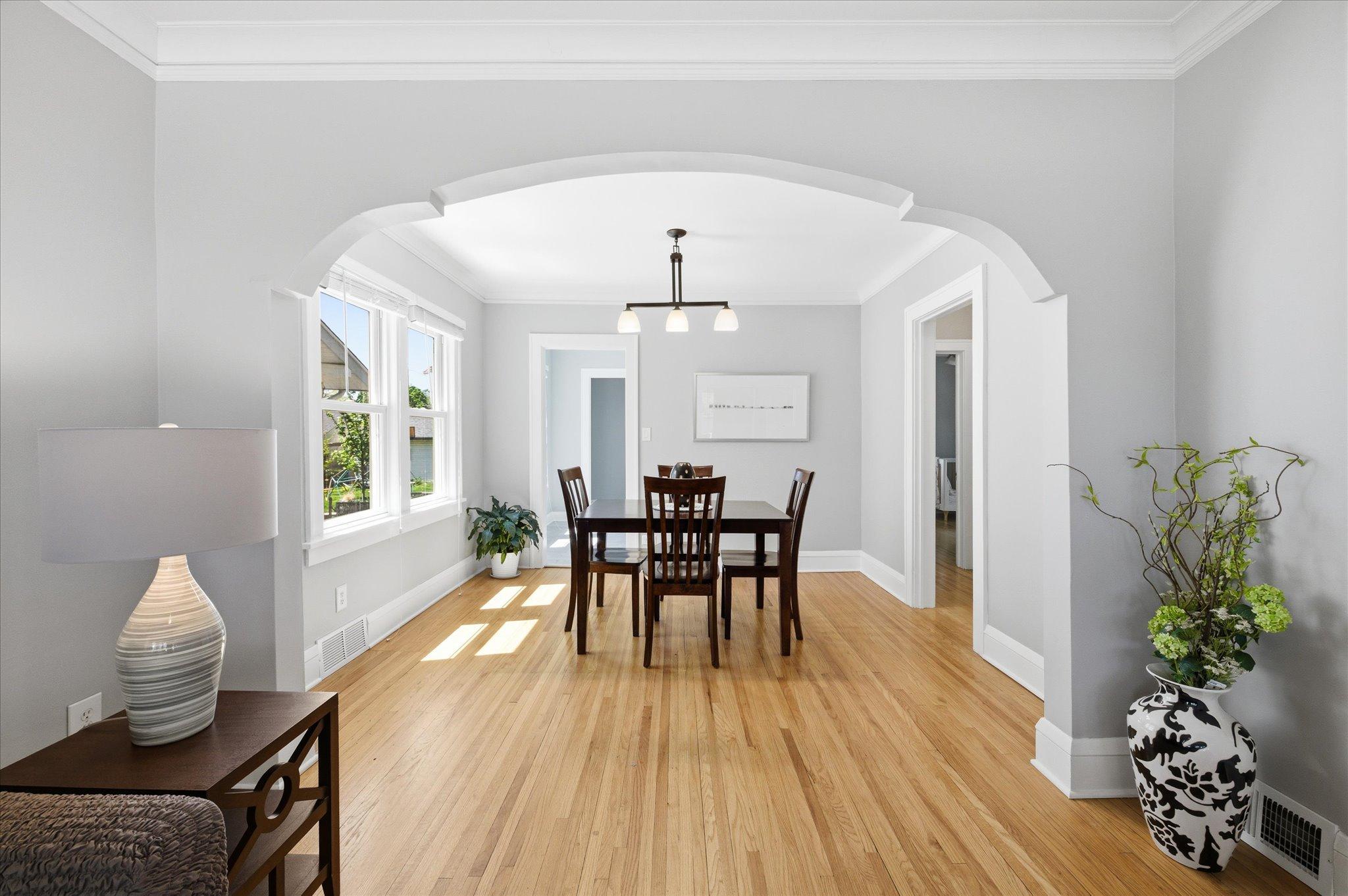 Bright and welcoming, the dining room features beautiful architectural details including a charming wall arch that adds timeless character.
