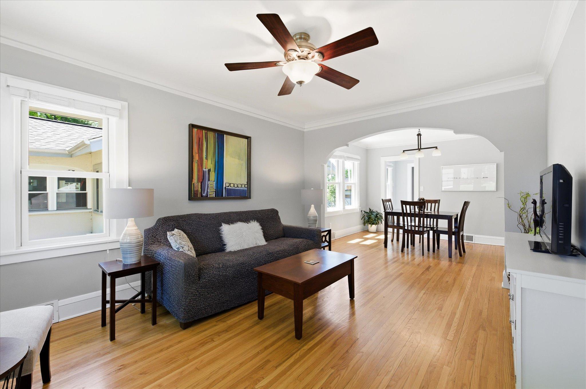 Gleaming hardwood floors and an open-concept layout make this living room feel warm, spacious, and full of character.