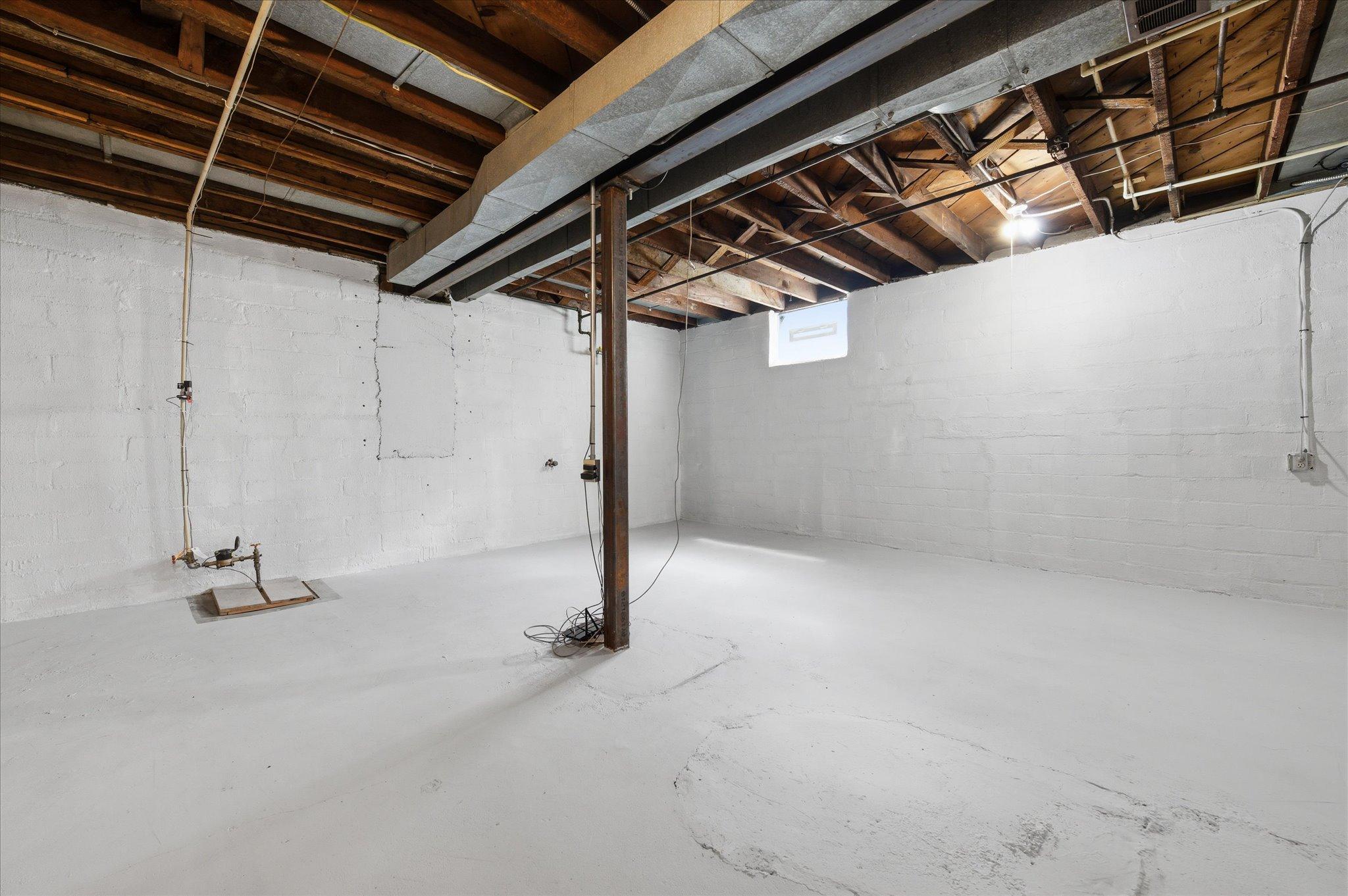 Tall ceilings make this unfinished basement stand out from typical homes of its time.
